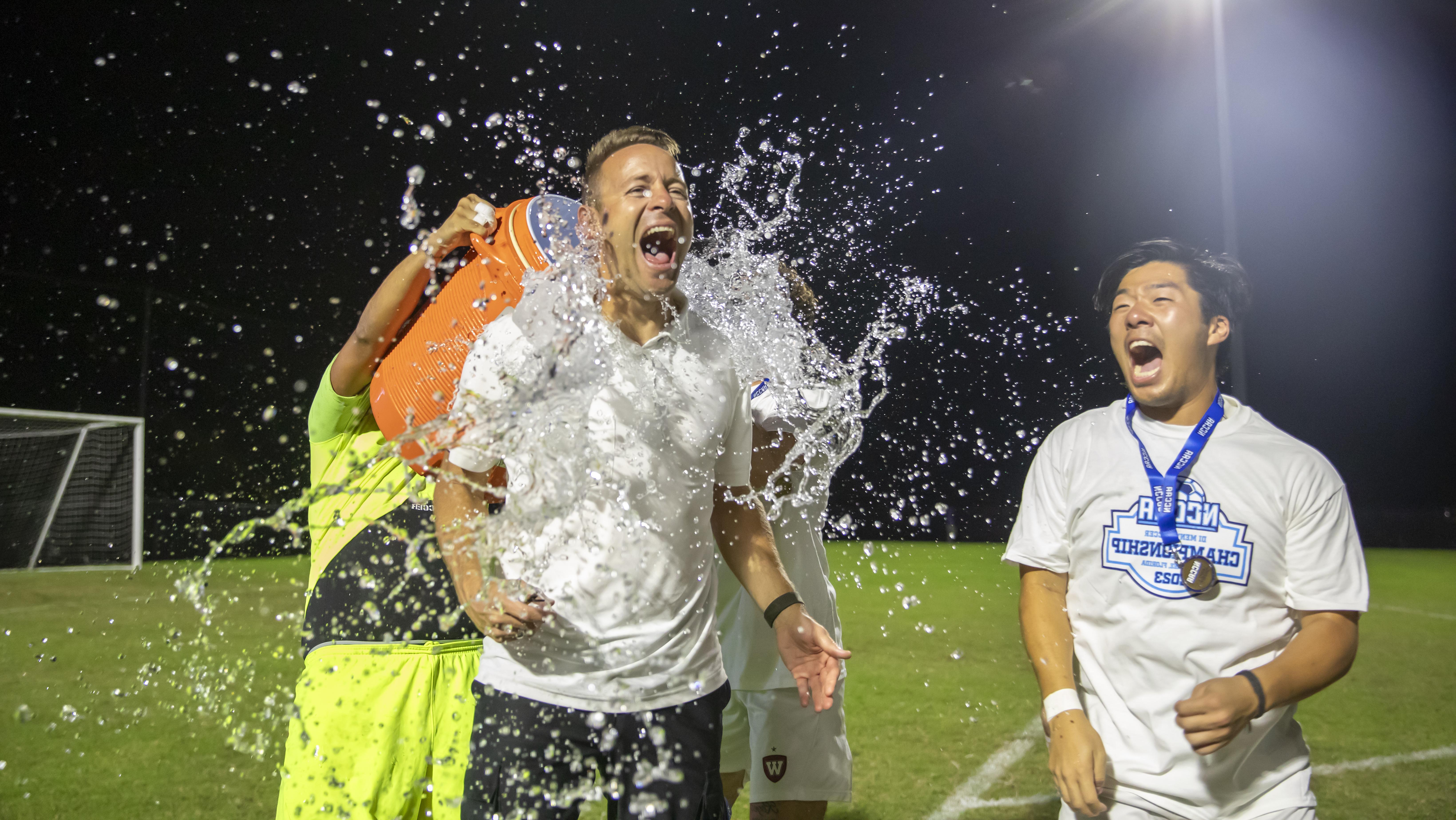 men's soccer water poured on player in celebration