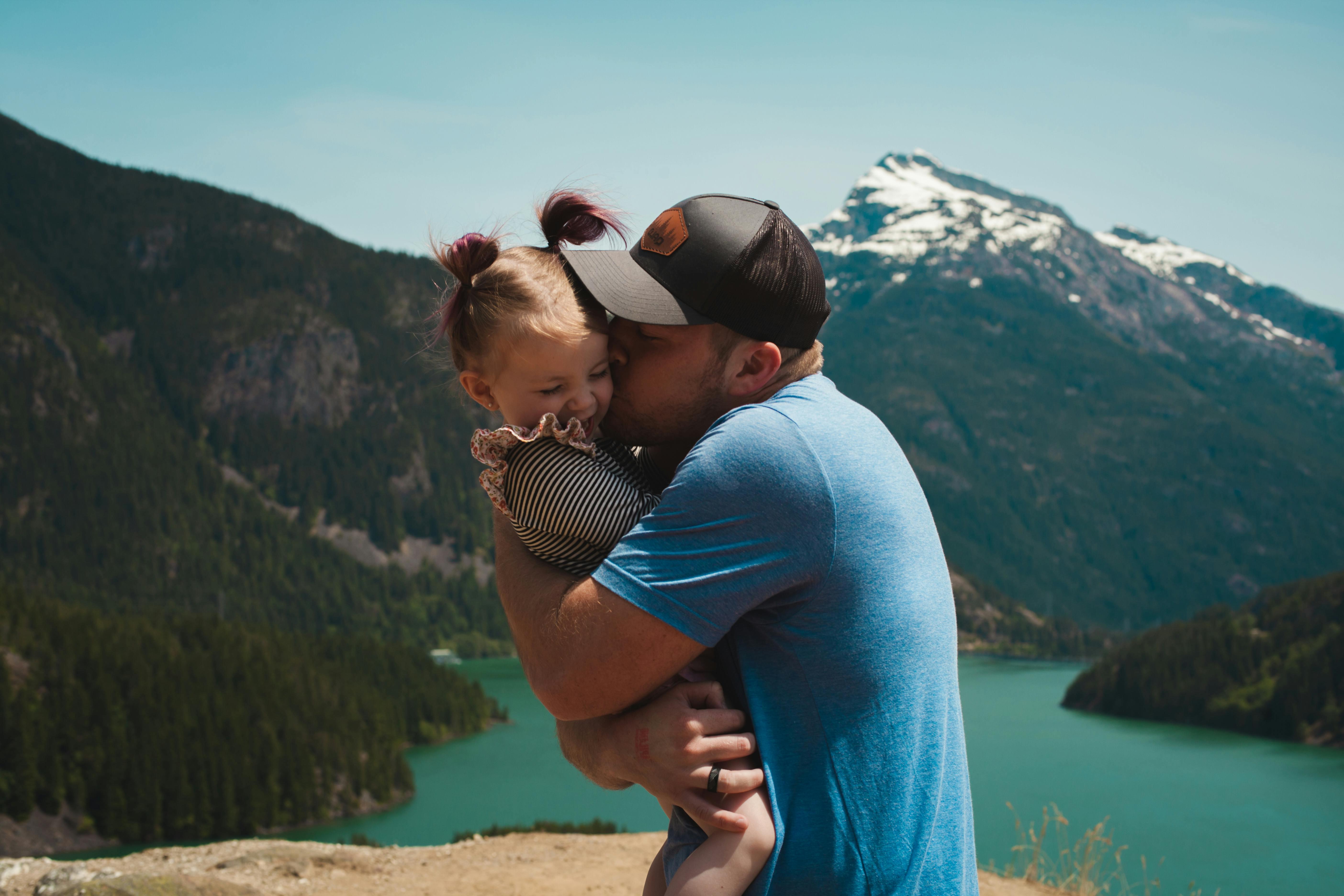 father caressing young daughter